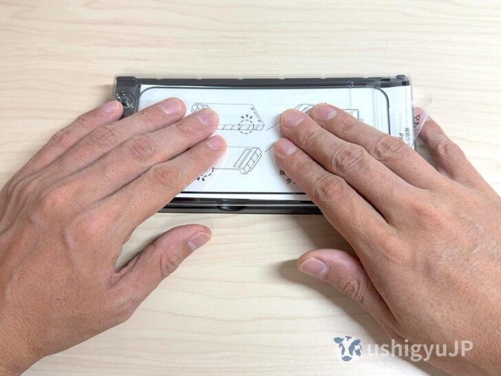 トレーのフタを押さえつけて、ホコリ取りテープをしっかりディスプレイに吸着させる